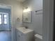 Bathroom with a mirror, towel rack and updated vanity and lighting at 807 Nectar Rd, Venice, FL 34293