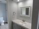 Bathroom with gray cabinets, white quartz countertops, new faucet, and a toilet in a separate space at 807 Nectar Rd, Venice, FL 34293
