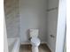 Bathroom with tile accent wall and updated fixtures including a toilet and towel rack at 807 Nectar Rd, Venice, FL 34293