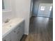 Bathroom with updated vanity, hardwood floors, and access to a bedroom at 807 Nectar Rd, Venice, FL 34293