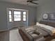 Bedroom featuring a bay window and modern decor on a cozy bed at 807 Nectar Rd, Venice, FL 34293