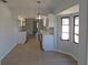 Dining room view into the updated kitchen with modern light fixture and windows at 807 Nectar Rd, Venice, FL 34293