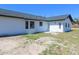 Rear home exterior featuring modern design elements and access door at 807 Nectar Rd, Venice, FL 34293