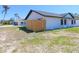 Home exterior featuring a modern fence and an expansive lawn at 807 Nectar Rd, Venice, FL 34293