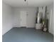 Interior garage view with painted floors, water heater, HVAC, and utility door at 807 Nectar Rd, Venice, FL 34293