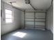 Spacious garage with an automatic door opener, window, and painted floor at 807 Nectar Rd, Venice, FL 34293