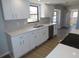 Updated kitchen with stainless appliances, white shaker cabinets, quartz countertops and gray subway tile at 807 Nectar Rd, Venice, FL 34293