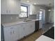 Modern kitchen featuring white cabinetry, stainless steel appliances, and a tile backsplash at 807 Nectar Rd, Venice, FL 34293