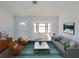 Bright and airy living room featuring a picture window, modern furnishings, and sleek wood flooring at 807 Nectar Rd, Venice, FL 34293