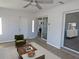 Staged living room features wood-look floors, a ceiling fan, and sliding glass doors to a patio at 807 Nectar Rd, Venice, FL 34293