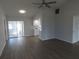 Open-concept living area with sliding glass doors and wood laminate flooring at 807 Nectar Rd, Venice, FL 34293