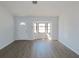 Bright and airy living room featuring a picture window, and sleek wood flooring at 807 Nectar Rd, Venice, FL 34293