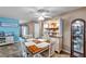 Inviting dining room with a wooden table, hutch, and modern ceiling fan at 865 48Th N Ave, St Petersburg, FL 33703