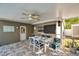 Comfortable covered patio with ceiling fan and table ready for outdoor dining at 865 48Th N Ave, St Petersburg, FL 33703