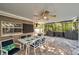 Outdoor dining area with ceiling fan, TV, and access to a grill area at 865 48Th N Ave, St Petersburg, FL 33703