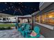 Inviting patio with comfortable seating, umbrella, and view of well-maintained yard at 865 48Th N Ave, St Petersburg, FL 33703