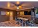 Covered outdoor dining area featuring ceiling fan, wall mounted TV, and outdoor decor at 865 48Th N Ave, St Petersburg, FL 33703