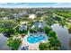 Scenic aerial view showcasing the community with a large pool area nestled amidst lush greenery at 115 112Th Ne Ave # 310, St Petersburg, FL 33716