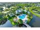 Aerial view of the community's large pool area with lush landscaping and surrounding waterways at 115 112Th Ne Ave # 310, St Petersburg, FL 33716