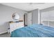 Bedroom with ceiling fan, queen size bed, dresser, and view through an open door at 115 112Th Ne Ave # 310, St Petersburg, FL 33716