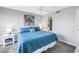 Bedroom featuring a ceiling fan, queen size bed, and flamingo wall art at 115 112Th Ne Ave # 310, St Petersburg, FL 33716