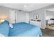 Bedroom featuring a ceiling fan, queen size bed, and a view into another room at 115 112Th Ne Ave # 310, St Petersburg, FL 33716