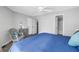 Cozy bedroom with ceiling fan, furniture, and view to bathroom at 115 112Th Ne Ave # 310, St Petersburg, FL 33716