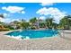 Expansive community pool with ample lounge seating and lush tropical landscaping around the area at 115 112Th Ne Ave # 310, St Petersburg, FL 33716