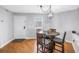 Cozy dining area featuring a modern light fixture, hardwood floors, and natural light at 115 112Th Ne Ave # 310, St Petersburg, FL 33716