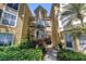 Charming condo building with vibrant landscaping and a welcoming walkway at 115 112Th Ne Ave # 310, St Petersburg, FL 33716