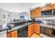 Kitchen featuring stainless steel appliances, granite counters, and an open view into the living room at 115 112Th Ne Ave # 310, St Petersburg, FL 33716