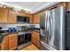Kitchen featuring stainless steel appliances, light wood cabinetry, and granite countertops at 115 112Th Ne Ave # 310, St Petersburg, FL 33716
