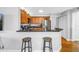 Open kitchen featuring stainless steel appliances, wooden cabinetry, and a breakfast bar with stools at 115 112Th Ne Ave # 310, St Petersburg, FL 33716