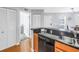 Kitchen featuring wooden cabinets and dark countertops, with view into hall and dining area at 115 112Th Ne Ave # 310, St Petersburg, FL 33716