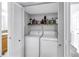 Convenient laundry closet with washer, dryer, and shelf for storage at 115 112Th Ne Ave # 310, St Petersburg, FL 33716