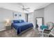 Bedroom featuring a ceiling fan, a gray accent wall, a large bed and a full length mirror at 115 112Th Ne Ave # 310, St Petersburg, FL 33716
