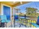 Screened-in patio with outdoor seating offers views of trees and surrounding buildings at 115 112Th Ne Ave # 310, St Petersburg, FL 33716