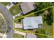 Aerial view of home showcasing the roof, driveway, and surrounding greenery at 11521 Rose Tree Dr, New Port Richey, FL 34654