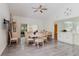 Bright dining area with wood floors and open access to the kitchen, living areas, and lanai at 11521 Rose Tree Dr, New Port Richey, FL 34654