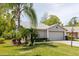 Lovely one-story home with a well-maintained lawn, mature palm trees, and an attached two-car garage at 11521 Rose Tree Dr, New Port Richey, FL 34654