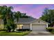 Charming one-story home with lush landscaping, private driveway, and attached two-car garage at 11521 Rose Tree Dr, New Port Richey, FL 34654