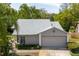Charming single Gathering home with a gray color palette, manicured landscaping, and a two-car garage at 11521 Rose Tree Dr, New Port Richey, FL 34654