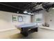 Game room featuring a well-maintained ping pong table and cue stick rack for entertainment at 11521 Rose Tree Dr, New Port Richey, FL 34654
