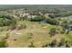 Scenic aerial view of the beautiful golf course, complete with lush greenery, water features, and manicured fairways at 11521 Rose Tree Dr, New Port Richey, FL 34654