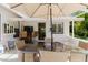 Covered patio with ample seating and outdoor TV perfect for entertaining guests at 11521 Rose Tree Dr, New Port Richey, FL 34654