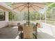 Relaxing covered patio with comfortable seating and serene outdoor view at 11521 Rose Tree Dr, New Port Richey, FL 34654