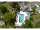 Aerial view of the community pool and clubhouse, showcasing a serene setting for relaxation and social gatherings at 11521 Rose Tree Dr, New Port Richey, FL 34654