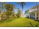Spacious backyard with lush greenery, offering a serene setting and partial view of the home at 118 Wall St, Redington Shores, FL 33708