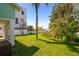 Lush backyard featuring tropical trees and a glimpse of water views, perfect for relaxation at 118 Wall St, Redington Shores, FL 33708