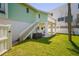 Well-maintained backyard with lush green grass and a inviting outdoor lounging area on the lower level at 118 Wall St, Redington Shores, FL 33708